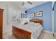 Inviting bedroom features a cozy bed, bright blue walls, and plenty of natural light at 2613 59Th S St, Gulfport, FL 33707