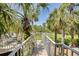 Wood deck with white railings surrounded by lush tropical landscaping at 2613 59Th S St, Gulfport, FL 33707