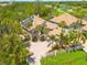 Aerial view of a home with lush landscaping and a paver driveway and solar panels at 2613 59Th S St, Gulfport, FL 33707