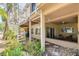 The exterior of the home features a spiral staircase, covered patio, and natural foliage at 2613 59Th S St, Gulfport, FL 33707