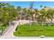 Front exterior featuring lush landscaping, paver driveway, and gated entry, set on a well maintained lot at 2613 59Th S St, Gulfport, FL 33707