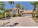 Beautiful home exterior with a brick driveway, a two-car garage, stone accents, and tropical landscaping at 2613 59Th S St, Gulfport, FL 33707