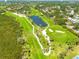 Aerial view of a pristine golf course with a pond, showcasing the manicured fairways at 2613 59Th S St, Gulfport, FL 33707