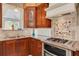 Well-appointed kitchen featuring custom wood cabinets, granite counters, and gas range at 2613 59Th S St, Gulfport, FL 33707