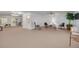 Open living room featuring neutral carpet, ample seating, and small tables at 2613 59Th S St, Gulfport, FL 33707