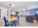 Open living room featuring blue accent walls, ample seating, and neutral carpet at 2613 59Th S St, Gulfport, FL 33707