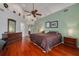 Spacious primary bedroom with hardwood floors, a ceiling fan, and an ensuite bathroom at 2613 59Th S St, Gulfport, FL 33707