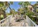 Elevated outdoor deck with a dining table and chairs, surrounded by lush landscaping and scenic views at 2613 59Th S St, Gulfport, FL 33707