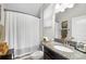 Bright bathroom with granite countertop, single sink, and shower behind patterned curtain at 28638 Tranquil Lake Cir, Wesley Chapel, FL 33543