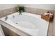 Relaxing bathtub with tile surround and ample space, perfect for unwinding after a long day at 28638 Tranquil Lake Cir, Wesley Chapel, FL 33543