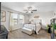 Bedroom featuring neutral walls, carpet flooring, a ceiling fan, and natural light, creating a relaxing atmosphere at 28638 Tranquil Lake Cir, Wesley Chapel, FL 33543