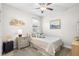Cozy bedroom featuring soft lighting, carpet flooring, and neutral decor, creating a tranquil retreat at 28638 Tranquil Lake Cir, Wesley Chapel, FL 33543