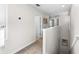Upstairs hallway with carpet flooring, natural light, and access to several rooms, offering comfortable passage at 28638 Tranquil Lake Cir, Wesley Chapel, FL 33543