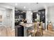 Modern kitchen with dark cabinetry, granite countertops, stainless steel appliances, and an island with seating at 28638 Tranquil Lake Cir, Wesley Chapel, FL 33543