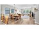 Open-concept living and dining area with hardwood floors, natural light, and modern furnishings at 28638 Tranquil Lake Cir, Wesley Chapel, FL 33543