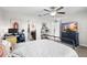 Main bedroom features carpet flooring, a ceiling fan, and a view into the ensuite bathroom and walk-in closet at 28638 Tranquil Lake Cir, Wesley Chapel, FL 33543