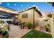 Backyard patio with string lights, grill, and fenced yard with artificial grass at 28638 Tranquil Lake Cir, Wesley Chapel, FL 33543