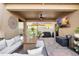 Covered patio with comfortable wicker seating, ceiling fan, and outdoor television at 28638 Tranquil Lake Cir, Wesley Chapel, FL 33543