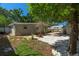 Cozy backyard featuring a stone pathway, white gravel, and a quaint patio area, perfect for outdoor relaxation at 2903 W Paxton Ave, Tampa, FL 33611