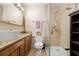 Bathroom with a modern sink, granite countertop, toilet, and walk-in glass shower stall at 2903 W Paxton Ave, Tampa, FL 33611