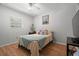 Bright bedroom with wood floors, natural light, and cozy furnishings at 2903 W Paxton Ave, Tampa, FL 33611