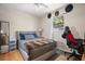 Bedroom with a queen-sized bed, natural light, and minimalist decor at 2903 W Paxton Ave, Tampa, FL 33611