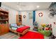 Cozy bedroom with a single bed, playful decor, and a bright red rug at 2903 W Paxton Ave, Tampa, FL 33611