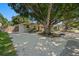 Cozy single-story home with mature tree, inviting curb appeal, and rocking chairs on front porch at 2903 W Paxton Ave, Tampa, FL 33611