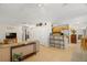 Open-concept living area features neutral tones, tile flooring and easy access to kitchen with breakfast bar at 2903 W Paxton Ave, Tampa, FL 33611