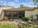 Charming backyard featuring a screened patio and a lush, green yard at 3203 Green Dolphin St, Tarpon Springs, FL 34689
