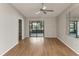 Bright bedroom featuring hardwood flooring, ceiling fan, sliding glass doors and plenty of natural light at 3203 Green Dolphin St, Tarpon Springs, FL 34689
