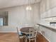Cozy dining area adjacent to the kitchen, featuring stylish lighting and hardwood floors at 3203 Green Dolphin St, Tarpon Springs, FL 34689
