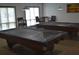 Comfortable game room features pool tables, chairs, and window with views at 3203 Green Dolphin St, Tarpon Springs, FL 34689
