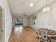 Inviting living room with hardwood floors, ceiling fan, and sliding glass doors to screened patio at 3203 Green Dolphin St, Tarpon Springs, FL 34689