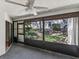 Cozy screened patio offers a serene view of the lush backyard landscape at 3203 Green Dolphin St, Tarpon Springs, FL 34689