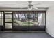 Cozy screened patio offers a serene view of the lush backyard landscape at 3203 Green Dolphin St, Tarpon Springs, FL 34689