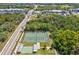 Overhead shot of the tennis and shuffleboard courts at this community near a busy throughfare at 3203 Green Dolphin St, Tarpon Springs, FL 34689