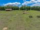 Expansive acreage featuring a charming home, lush pastures, and outbuildings, perfect for a serene country lifestyle at 35657 Ashley Ln, Dade City, FL 33523