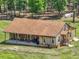 Expansive property featuring a charming wooden home with a spacious porch and lush surroundings at 35657 Ashley Ln, Dade City, FL 33523