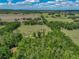 Sprawling land featuring the home encircled by a mix of open fields and dense woodlands, ensuring ultimate privacy at 35657 Ashley Ln, Dade City, FL 33523