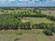 Beautiful aerial view captures the home surrounded by vibrant greenery, providing a tranquil and secluded setting at 35657 Ashley Ln, Dade City, FL 33523