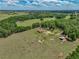 Gorgeous aerial view of a home with surrounding fields and trees at 35657 Ashley Ln, Dade City, FL 33523