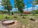 Spacious backyard with fire pit and picnic tables, ideal for outdoor gatherings at 35657 Ashley Ln, Dade City, FL 33523