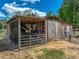 Rustic barn featuring wooden construction, metal roofing and fenced enclosure at 35657 Ashley Ln, Dade City, FL 33523
