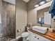 Modern bathroom featuring a unique vanity, stylish fixtures, and a walk-in shower at 35657 Ashley Ln, Dade City, FL 33523