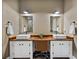 Bathroom featuring dual sinks with a wood countertop and stylish fixtures at 35657 Ashley Ln, Dade City, FL 33523