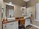 Bathroom featuring dual sinks with a wood countertop and stylish fixtures at 35657 Ashley Ln, Dade City, FL 33523