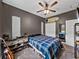 Well-lit bedroom with closet and mounted surfboard at 35657 Ashley Ln, Dade City, FL 33523