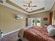 Bedroom with ceiling fan, TV, and access to the outdoors through French doors at 35657 Ashley Ln, Dade City, FL 33523