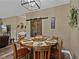 Inviting dining area with a round table, seating for six, and rustic sliding barn doors at 35657 Ashley Ln, Dade City, FL 33523